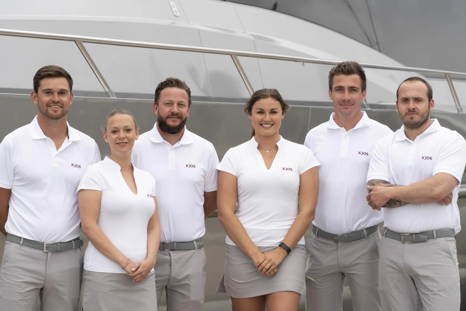 a group of people posing for a photo aboard KJOS Yacht for Charter