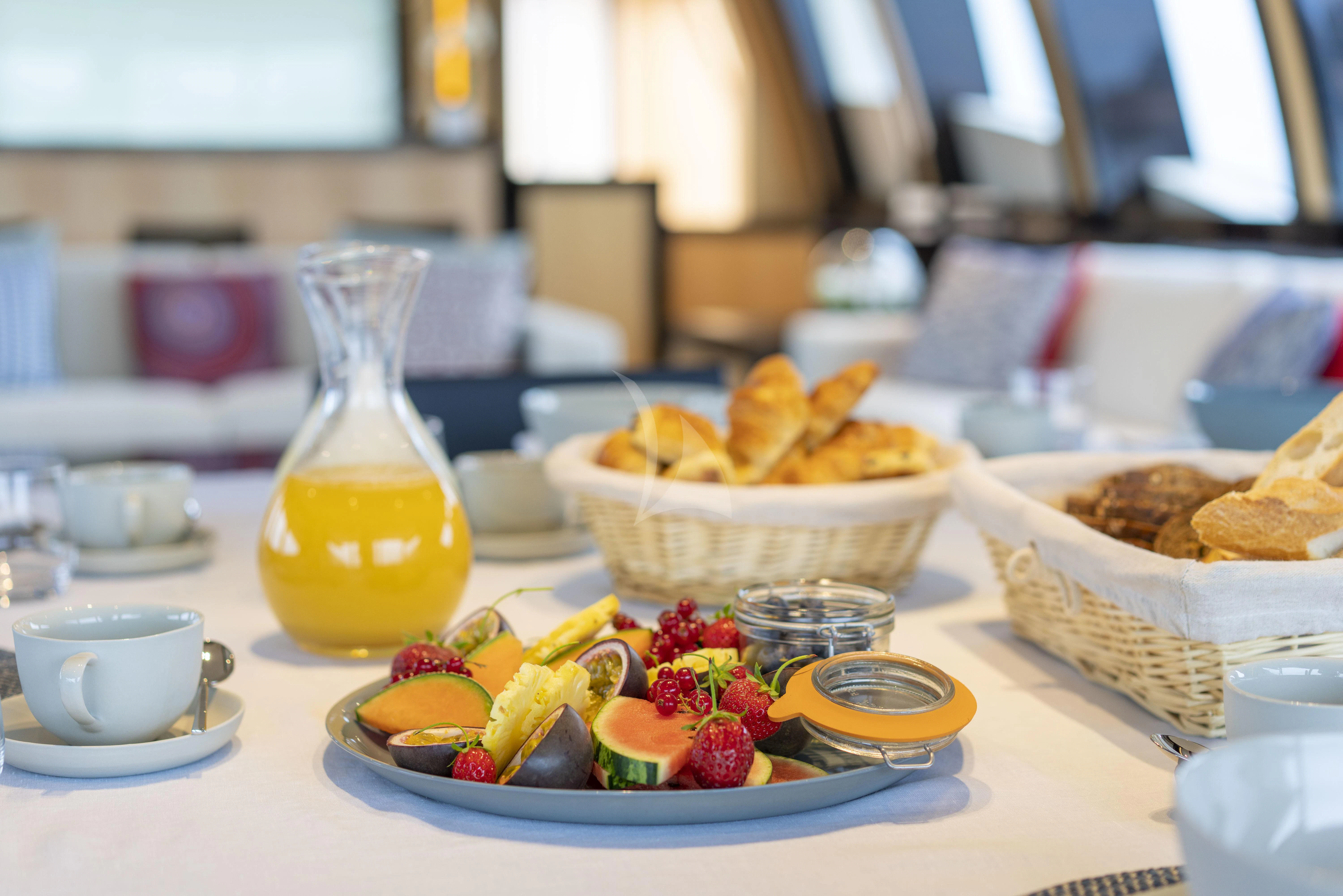 a table with food and drinks aboard KJOS Yacht for Charter
