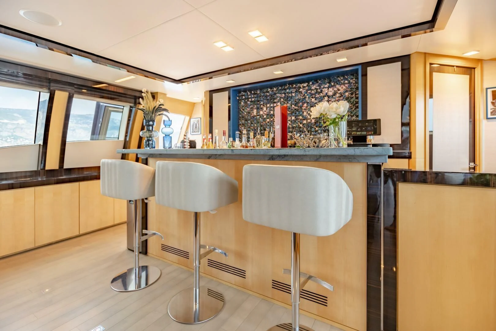 a bar with stools and stools aboard KJOS Yacht for Charter