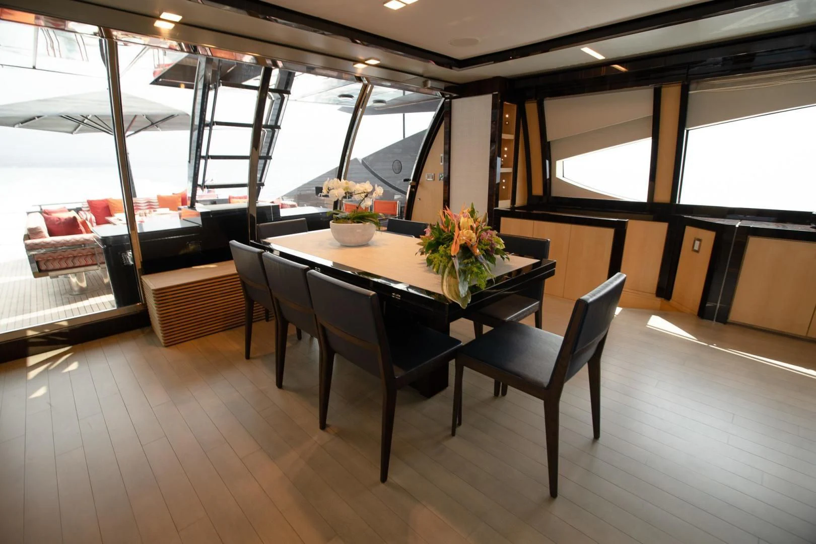 a room with a table and chairs aboard KJOS Yacht for Charter