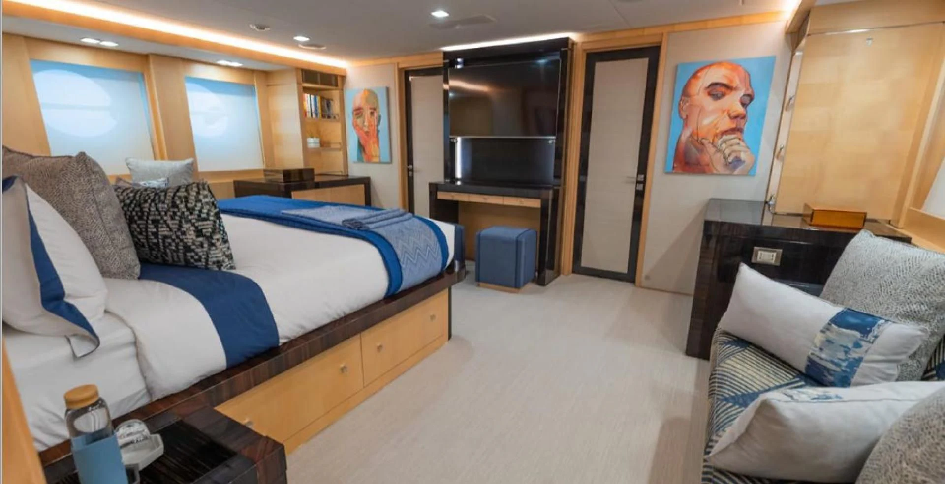 a bedroom with a bed and a tv aboard KJOS Yacht for Charter