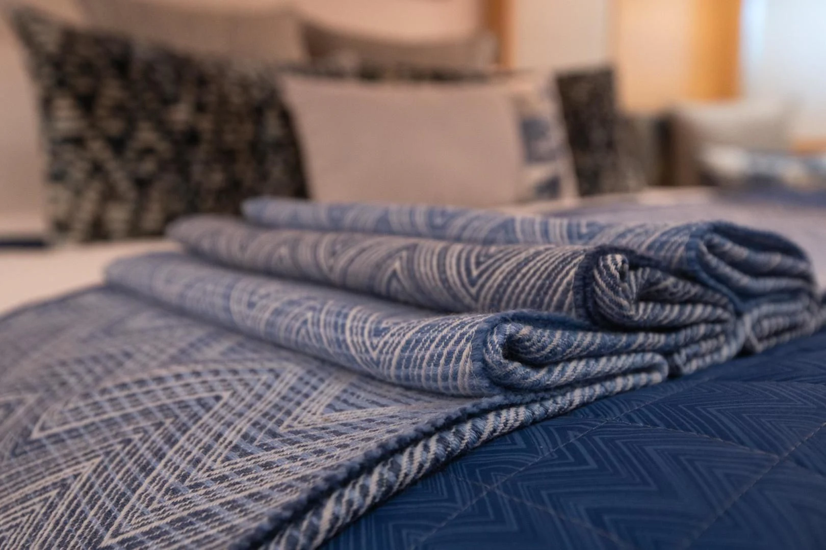 a bed with a blue sheet aboard KJOS Yacht for Charter