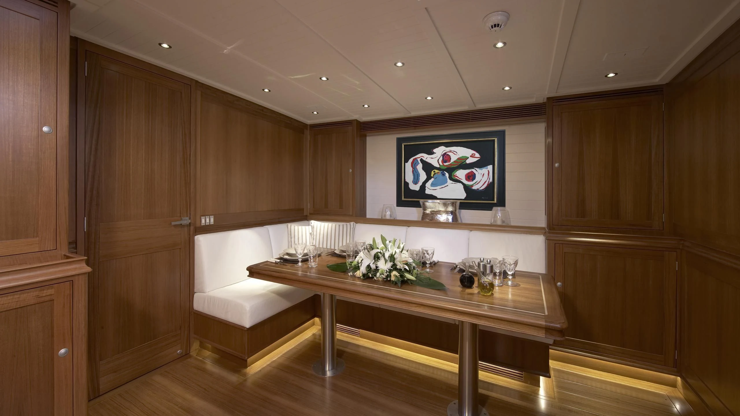 a room with a table and chairs aboard LIONHEART Yacht for Sale