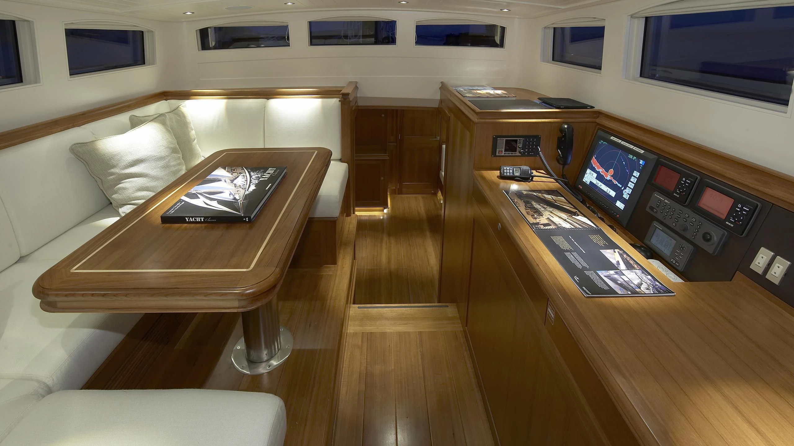 a room with a couch and a table with a laptop on it aboard LIONHEART Yacht for Sale