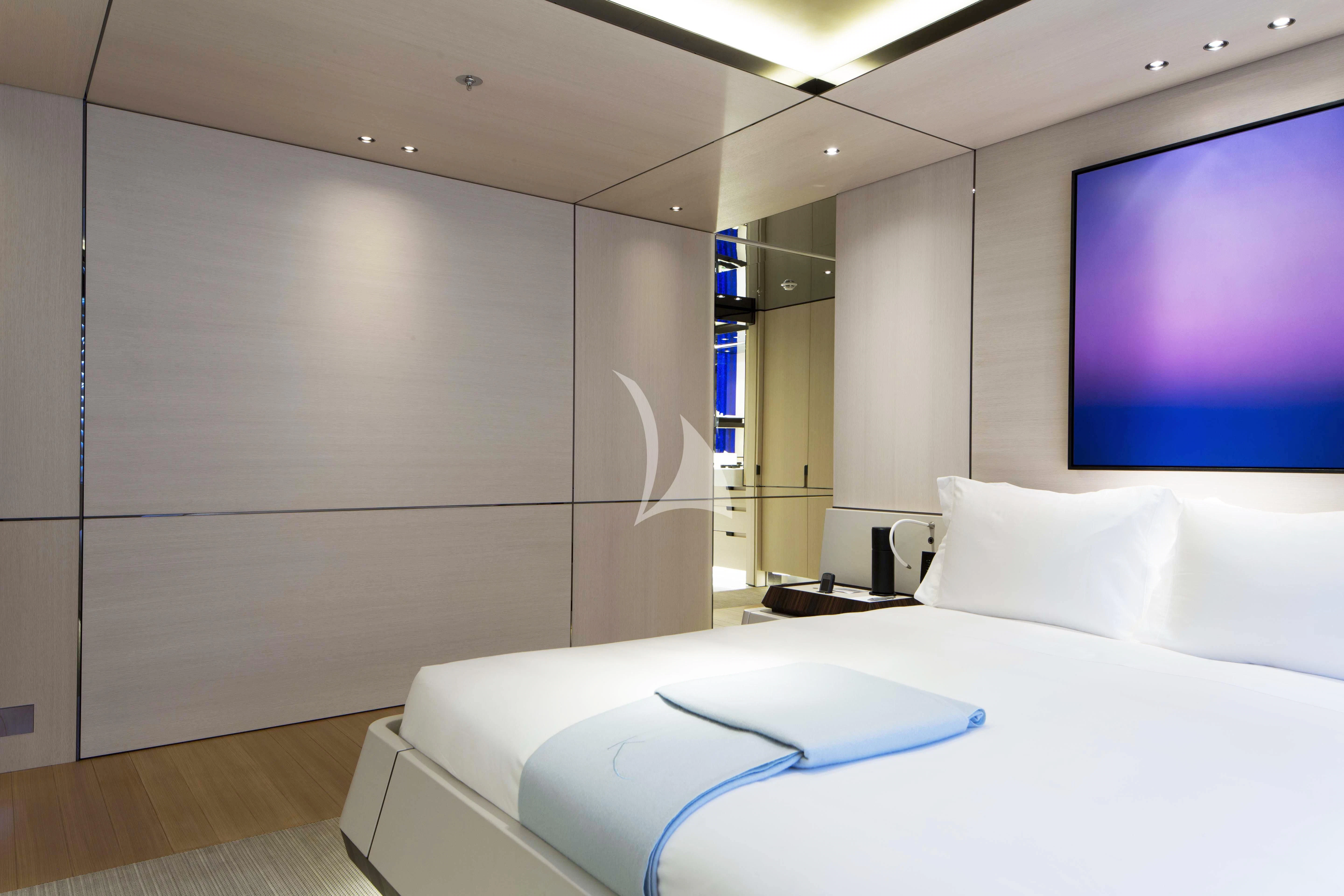 a bed with a blue blanket aboard KAMALAYA Yacht for Sale