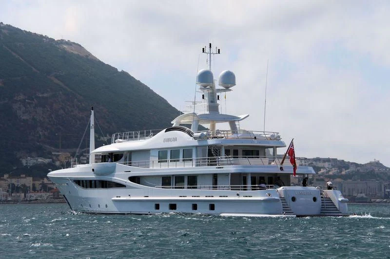 a large white boat in the water aboard KAMALAYA Yacht for Sale