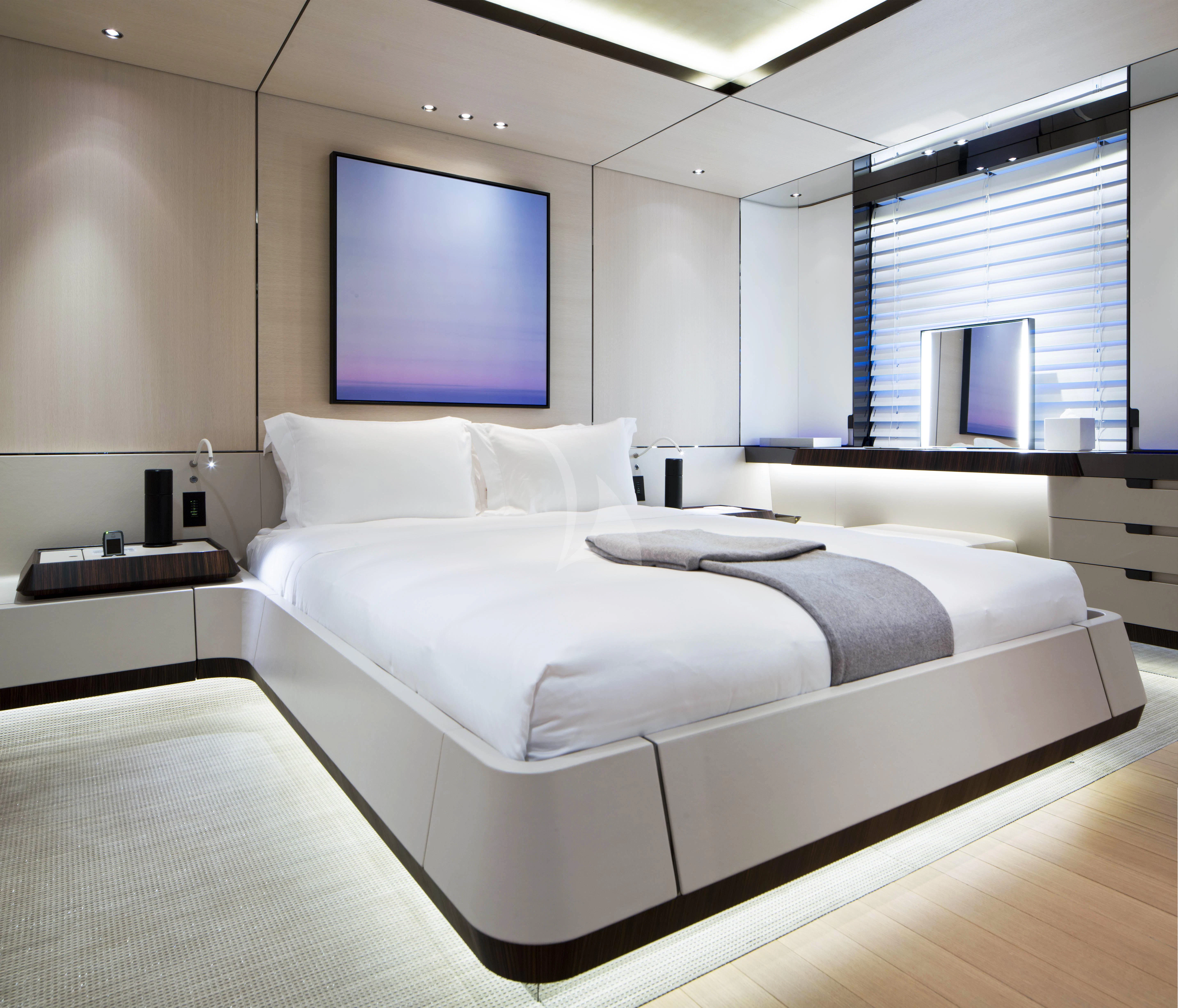 a room with a bed and a tv on the wall aboard KAMALAYA Yacht for Sale