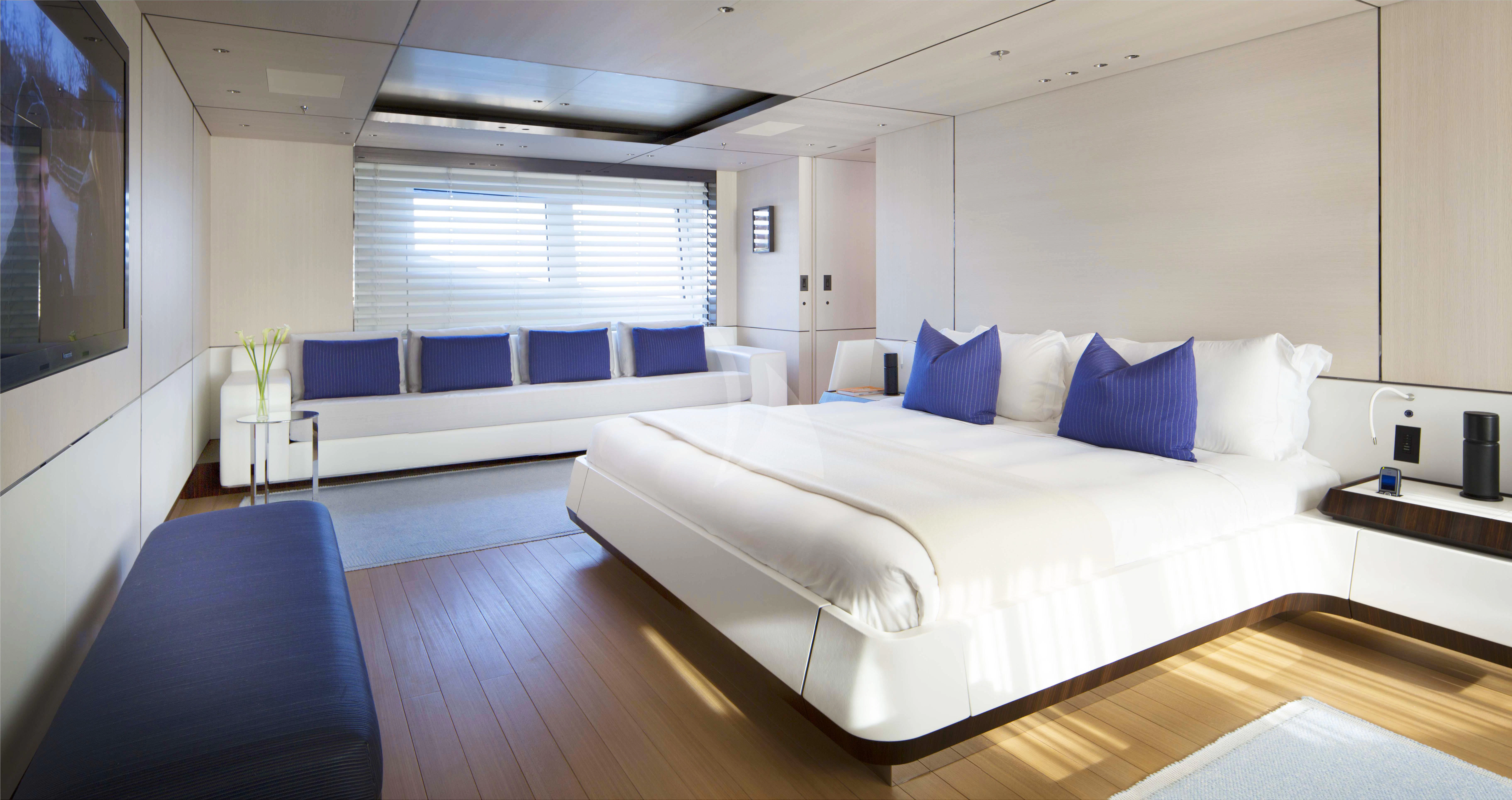 a room with a bed and a tv aboard KAMALAYA Yacht for Sale