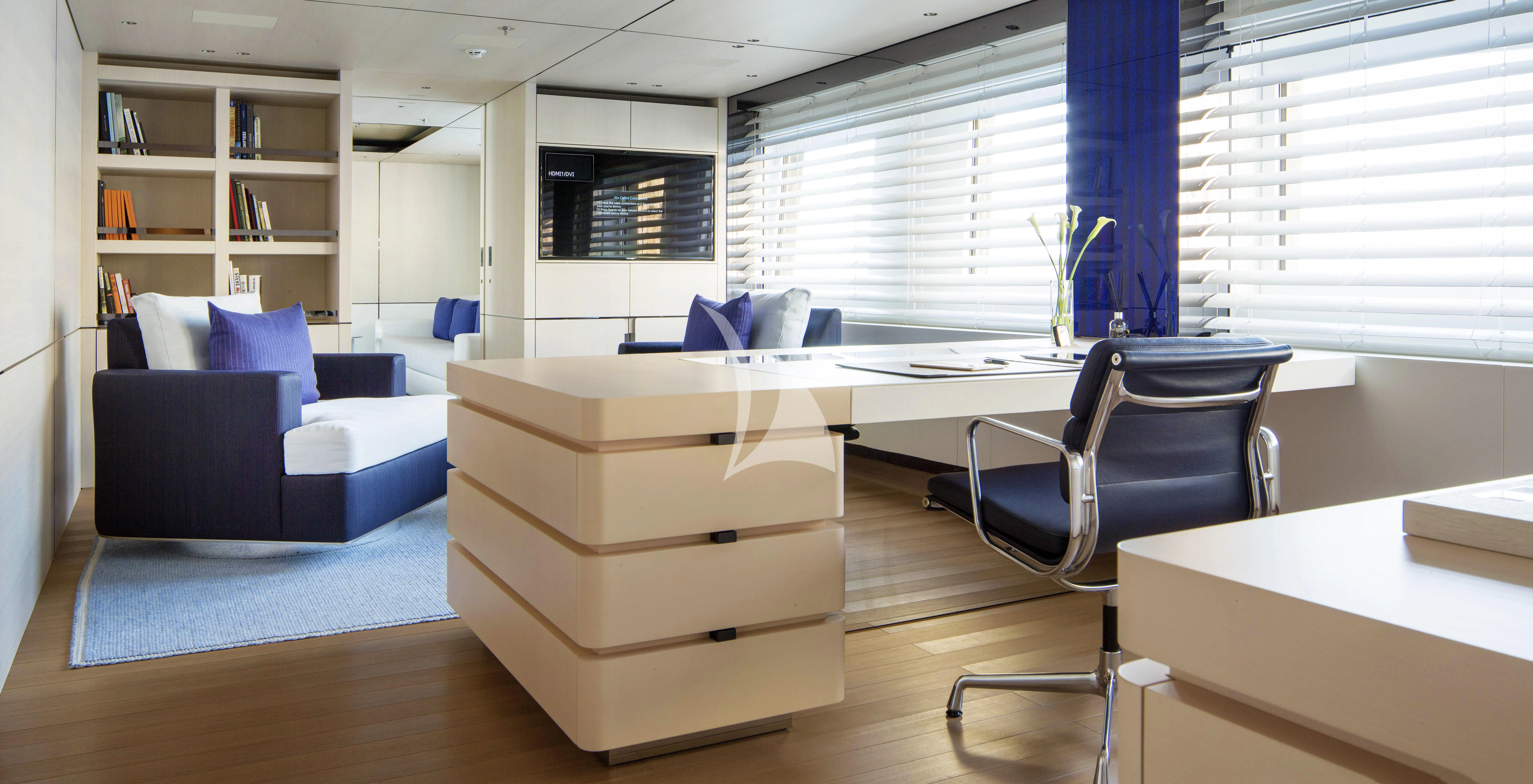 a room with a desk and a couch aboard KAMALAYA Yacht for Sale