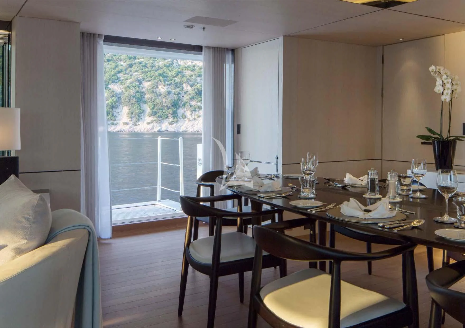 a dining table and chairs in a room aboard KAMALAYA Yacht for Sale