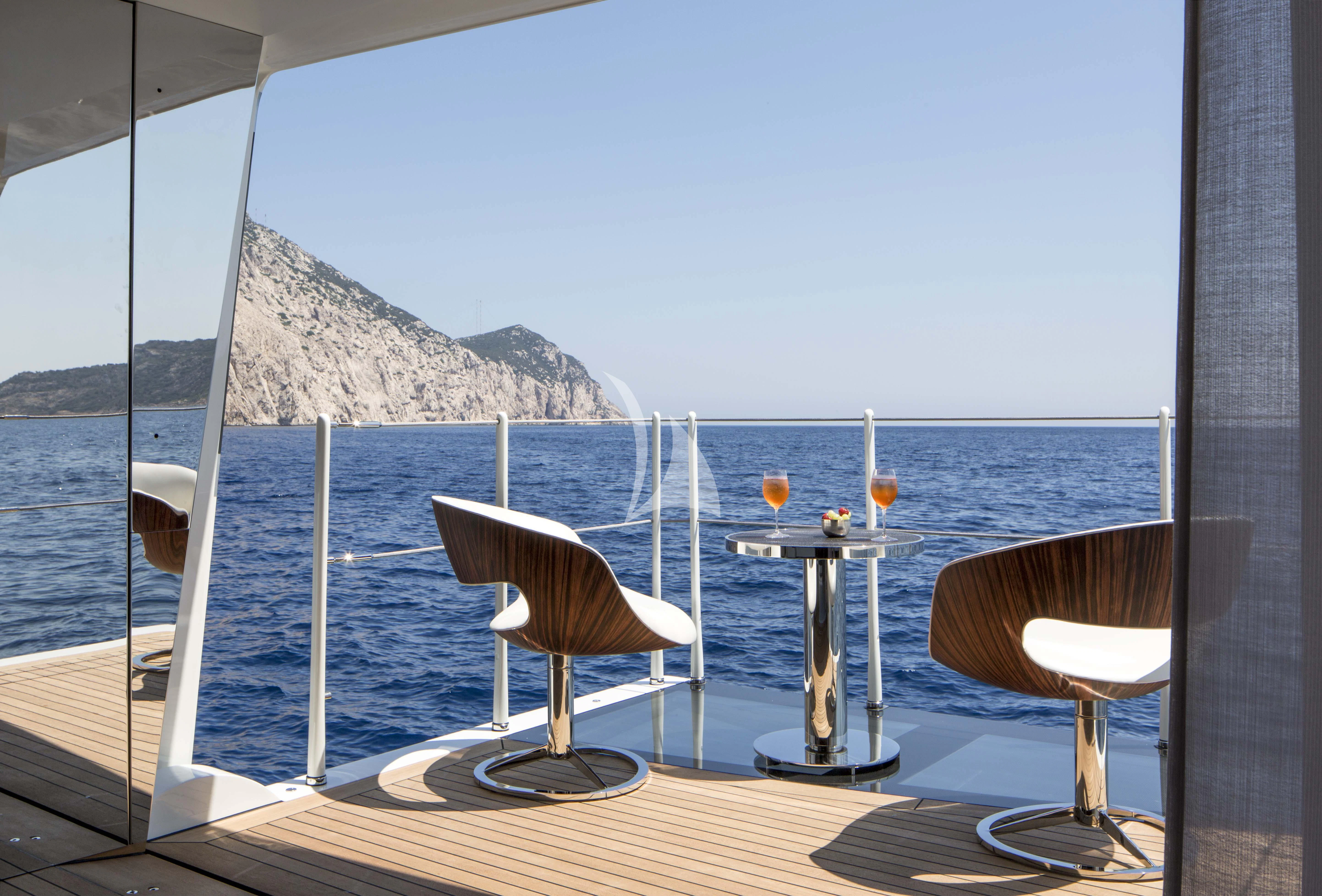 a room with a view of the ocean and mountains aboard KAMALAYA Yacht for Sale