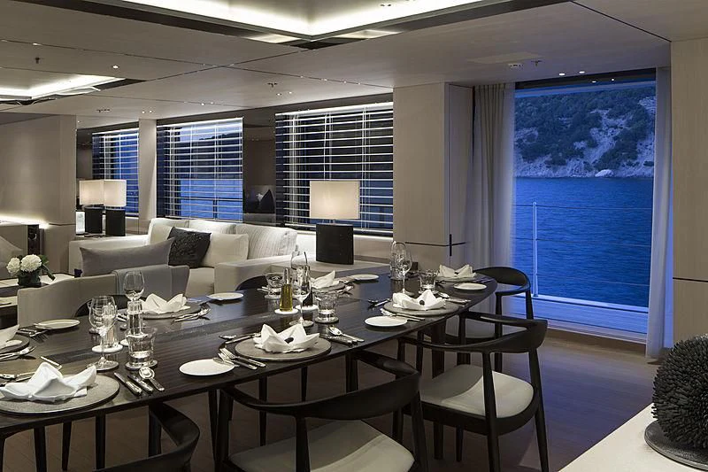 a large table with wine glasses on it aboard KAMALAYA Yacht for Sale