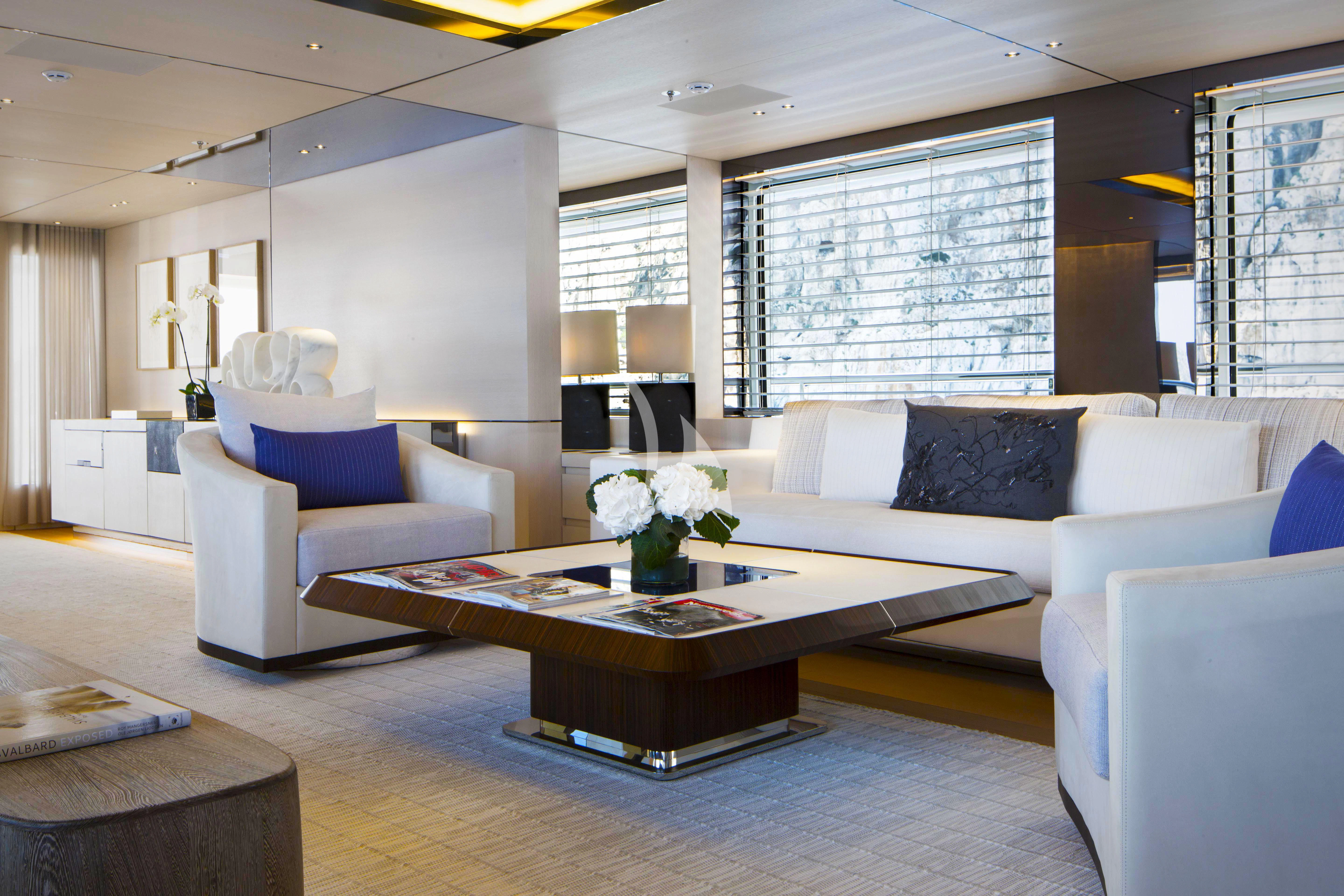 a living room with white couches aboard KAMALAYA Yacht for Sale