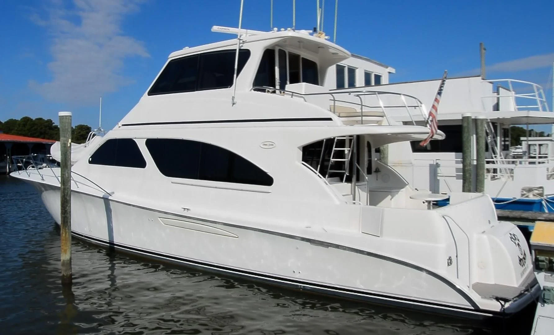 a white yacht docked aboard DOG HOUSE Yacht for Sale