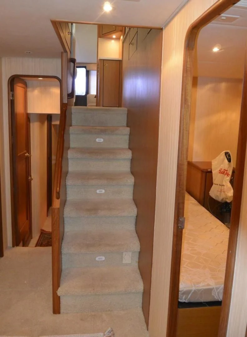 a wooden staircase in a house aboard DOG HOUSE Yacht for Sale