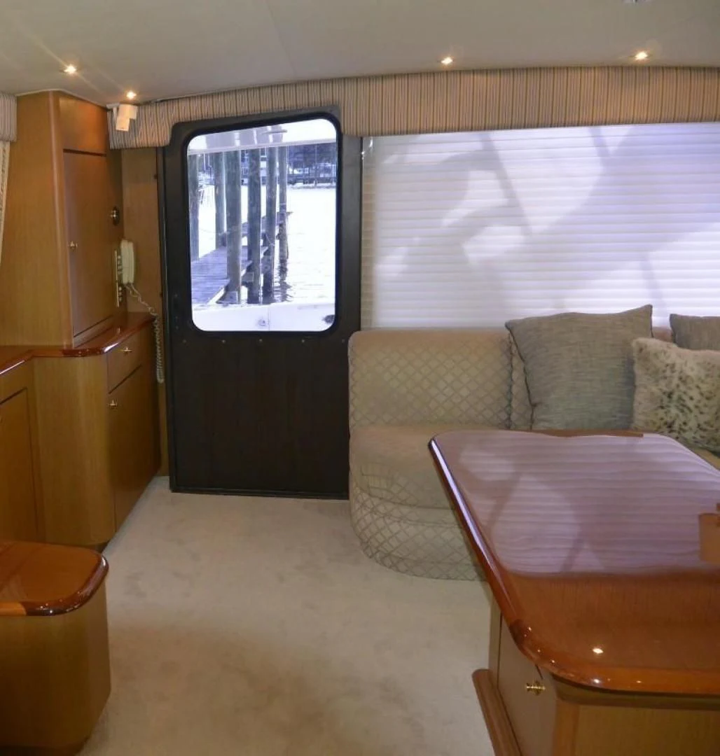 a living room with a couch and a table aboard DOG HOUSE Yacht for Sale