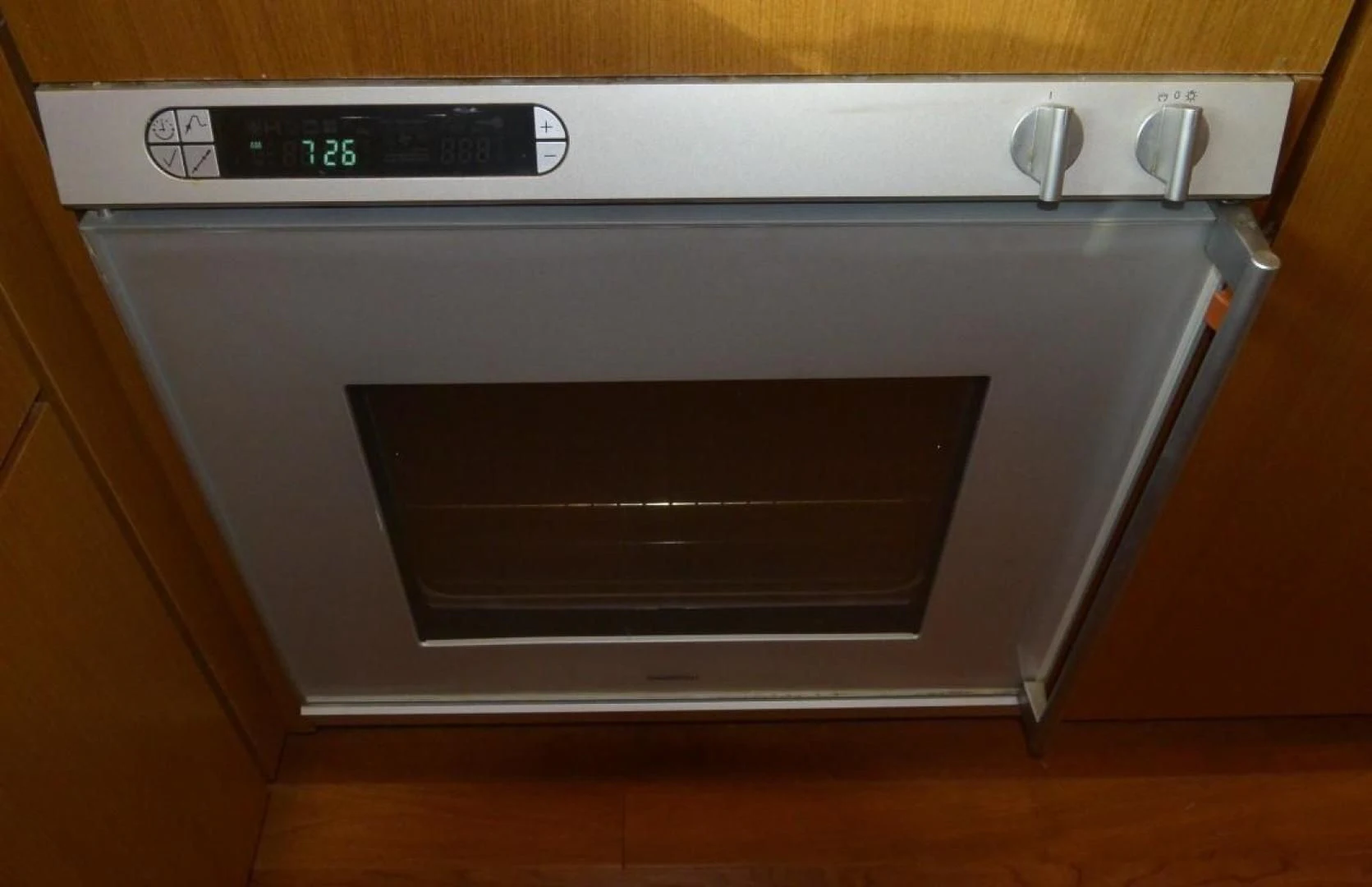 a silver oven with a digital clock aboard DOG HOUSE Yacht for Sale