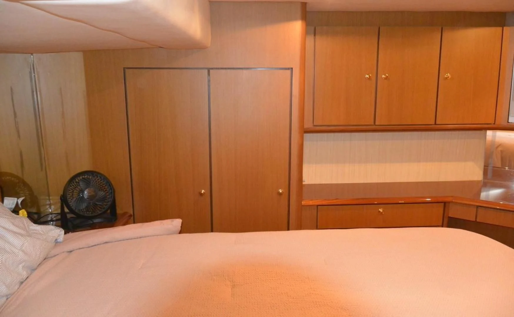 a bedroom with a fan aboard DOG HOUSE Yacht for Sale