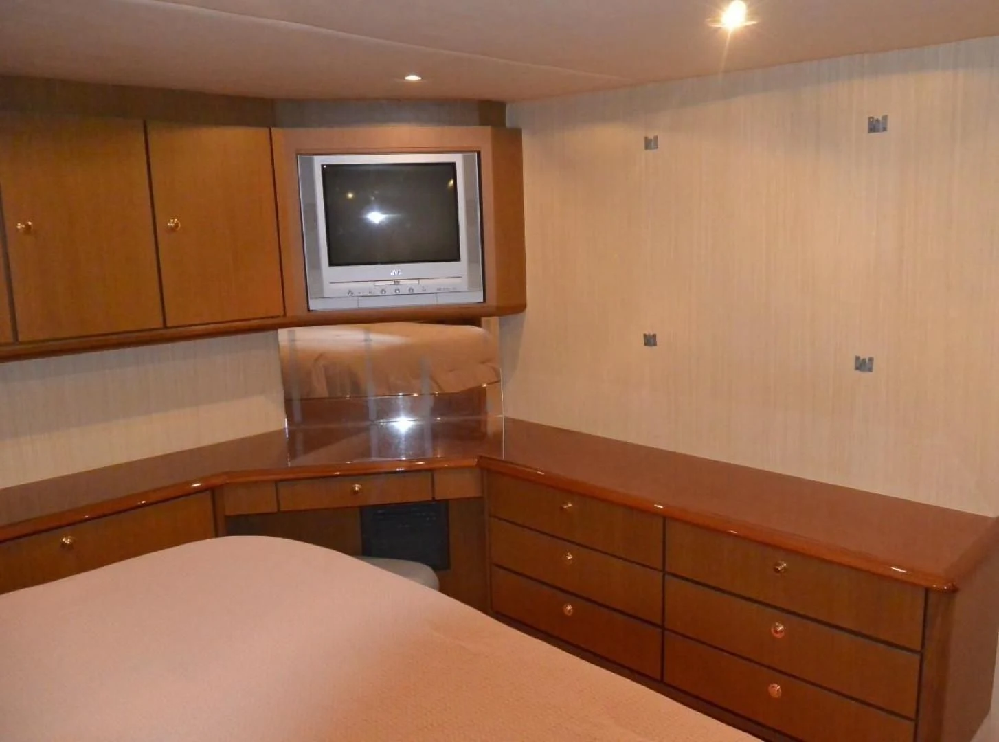 a room with a tv and dresser aboard DOG HOUSE Yacht for Sale