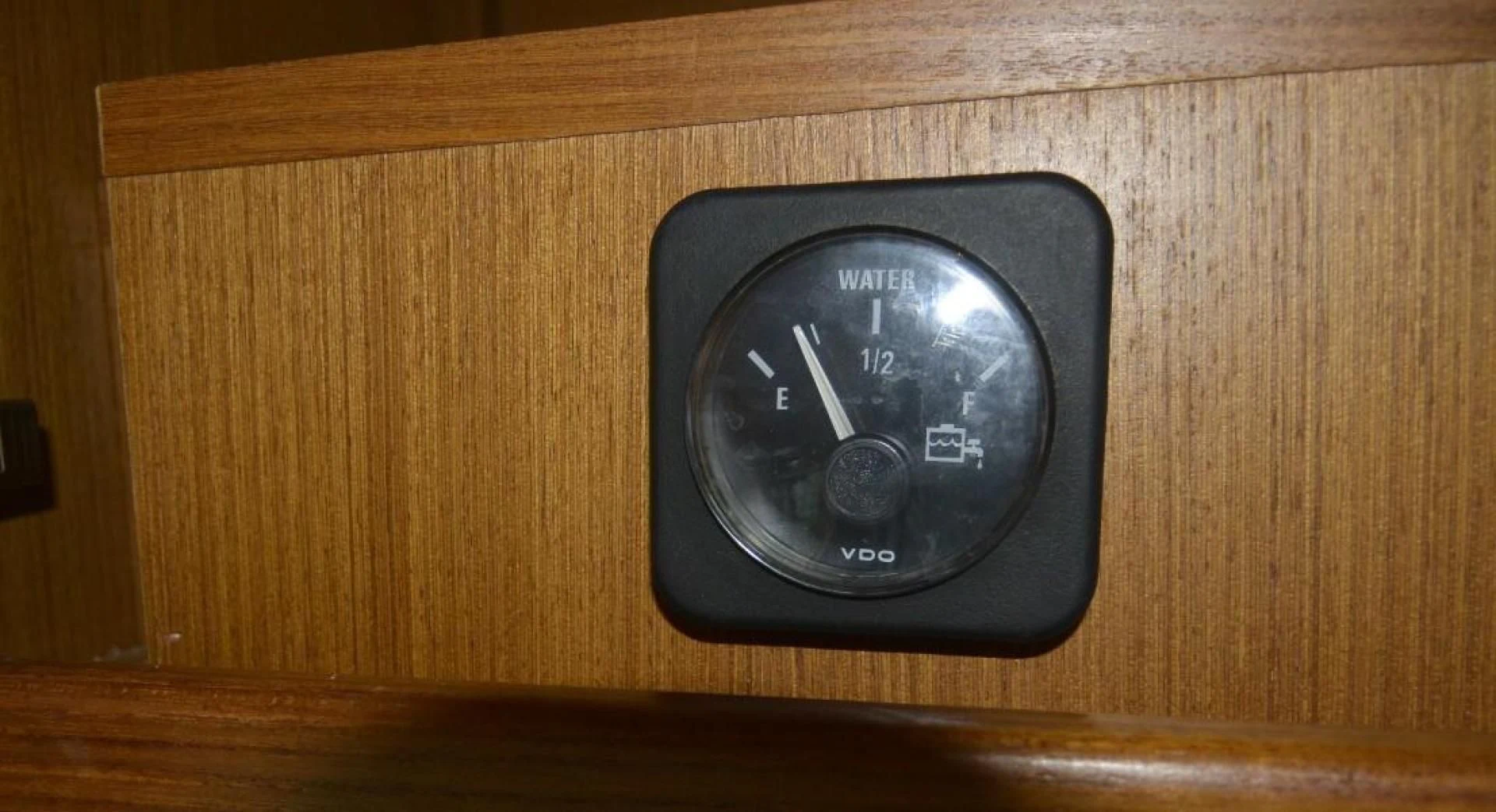 a black watch on a wooden surface aboard DOG HOUSE Yacht for Sale