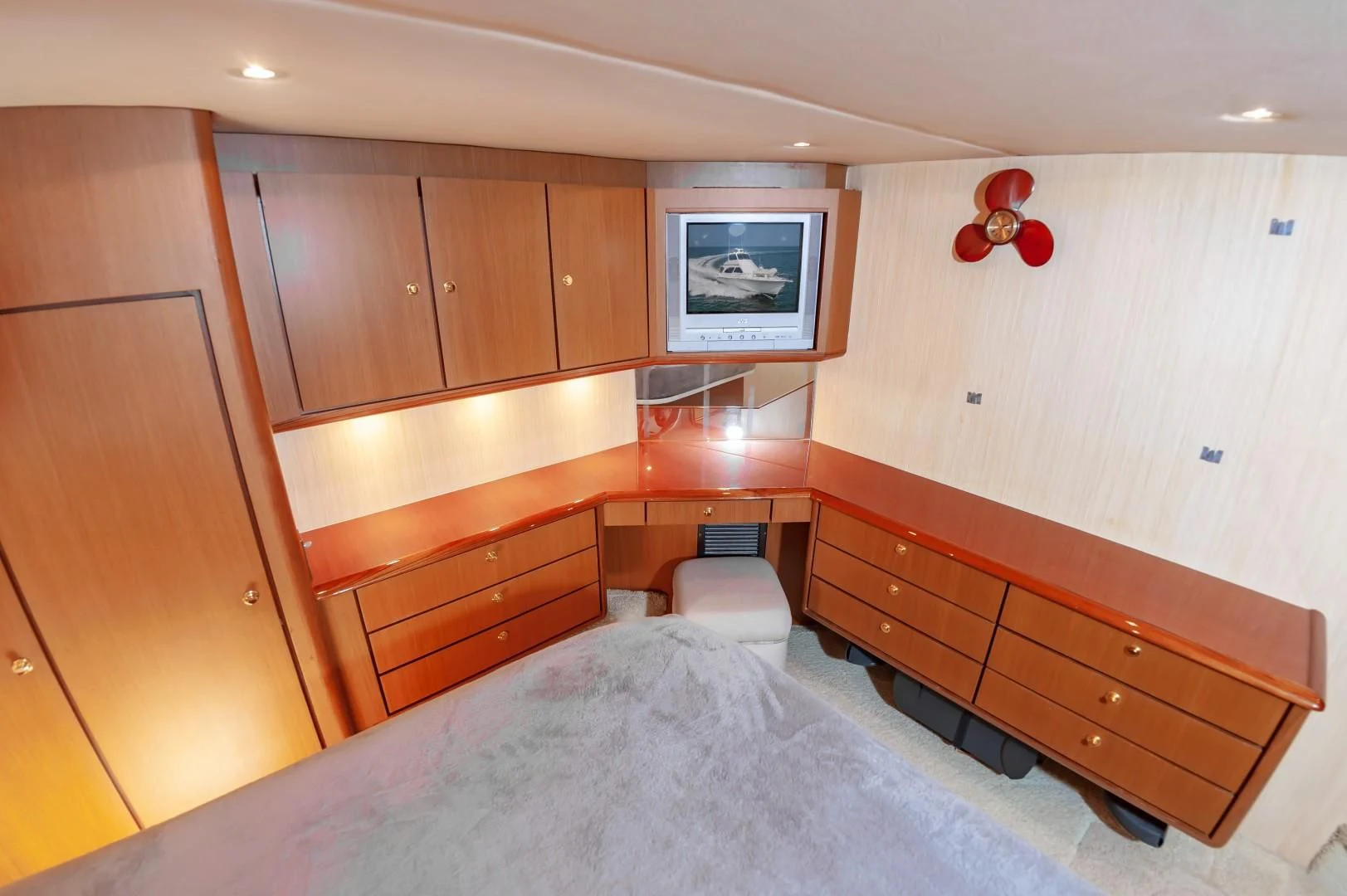 a bedroom with wooden cabinets aboard DOG HOUSE Yacht for Sale