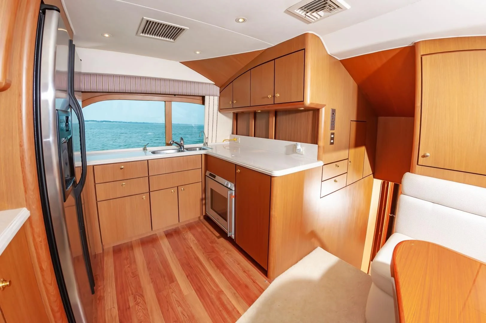 a kitchen with wooden cabinets aboard DOG HOUSE Yacht for Sale