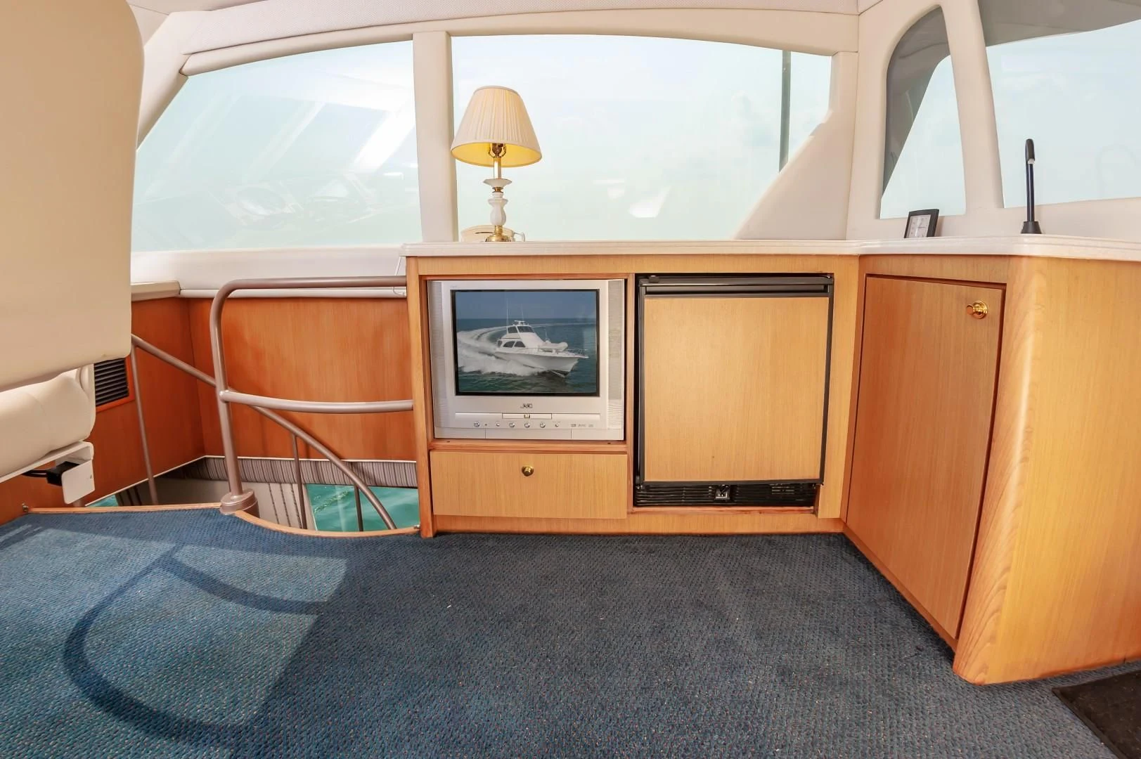 a room with a television and a lamp on the wall aboard DOG HOUSE Yacht for Sale