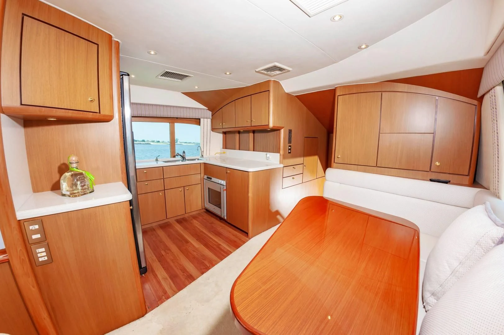 a kitchen with a table and a refrigerator aboard DOG HOUSE Yacht for Sale