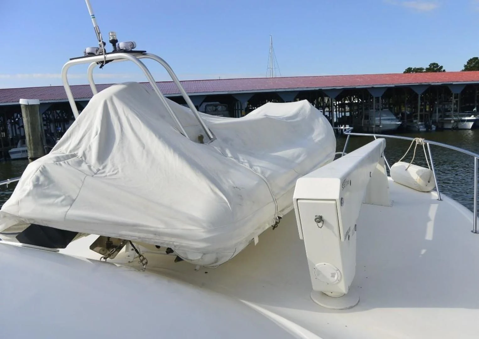 a white boat with a white cover aboard DOG HOUSE Yacht for Sale