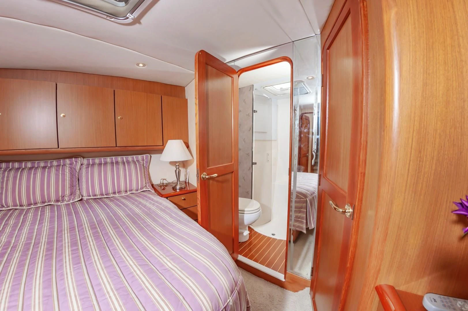 a bedroom with a bed and a closet aboard DOG HOUSE Yacht for Sale