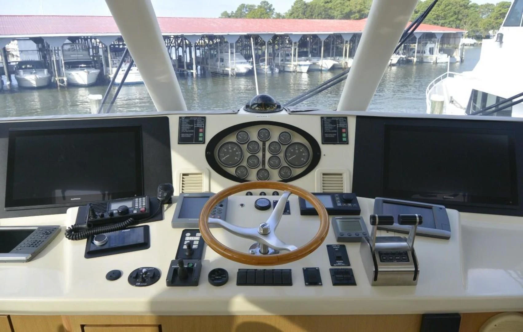 a control panel with a monitor and other electronics on it aboard DOG HOUSE Yacht for Sale