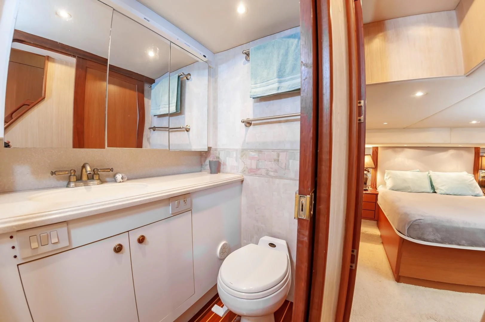 a bathroom with a sink toilet and a mirror aboard DOG HOUSE Yacht for Sale