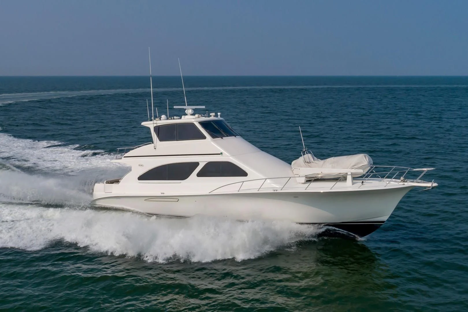 a white yacht in the water aboard DOG HOUSE Yacht for Sale