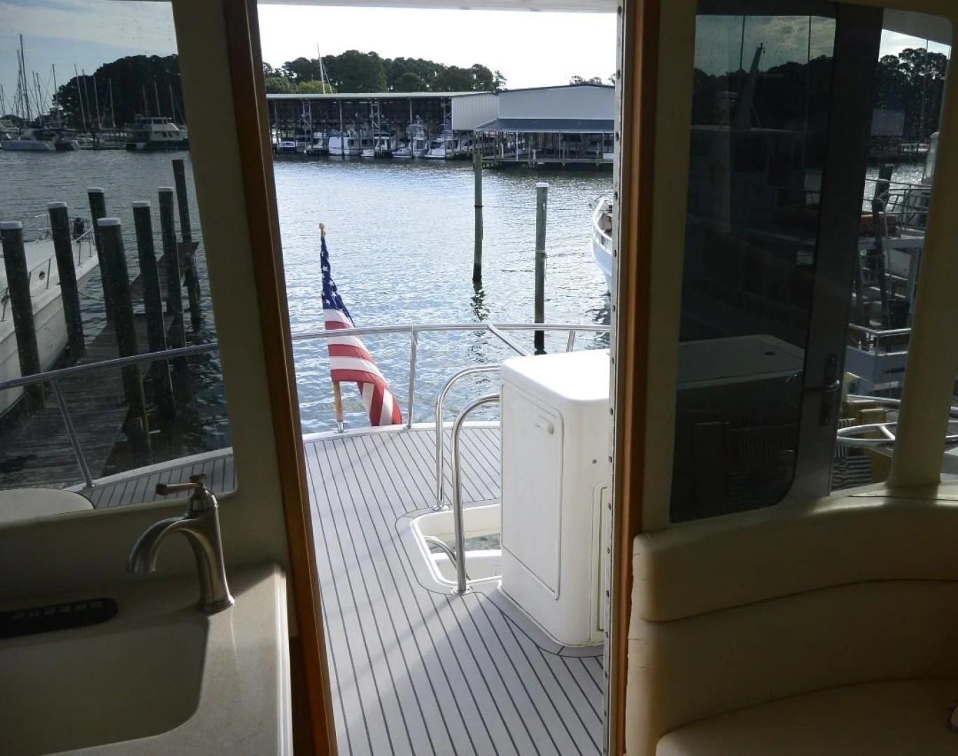 a view of a boat deck with a flag on the deck aboard DOG HOUSE Yacht for Sale
