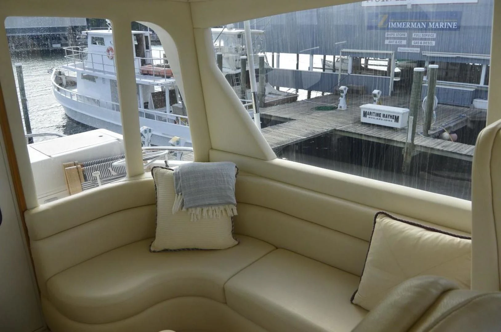 a couch and a window overlooking a city aboard DOG HOUSE Yacht for Sale