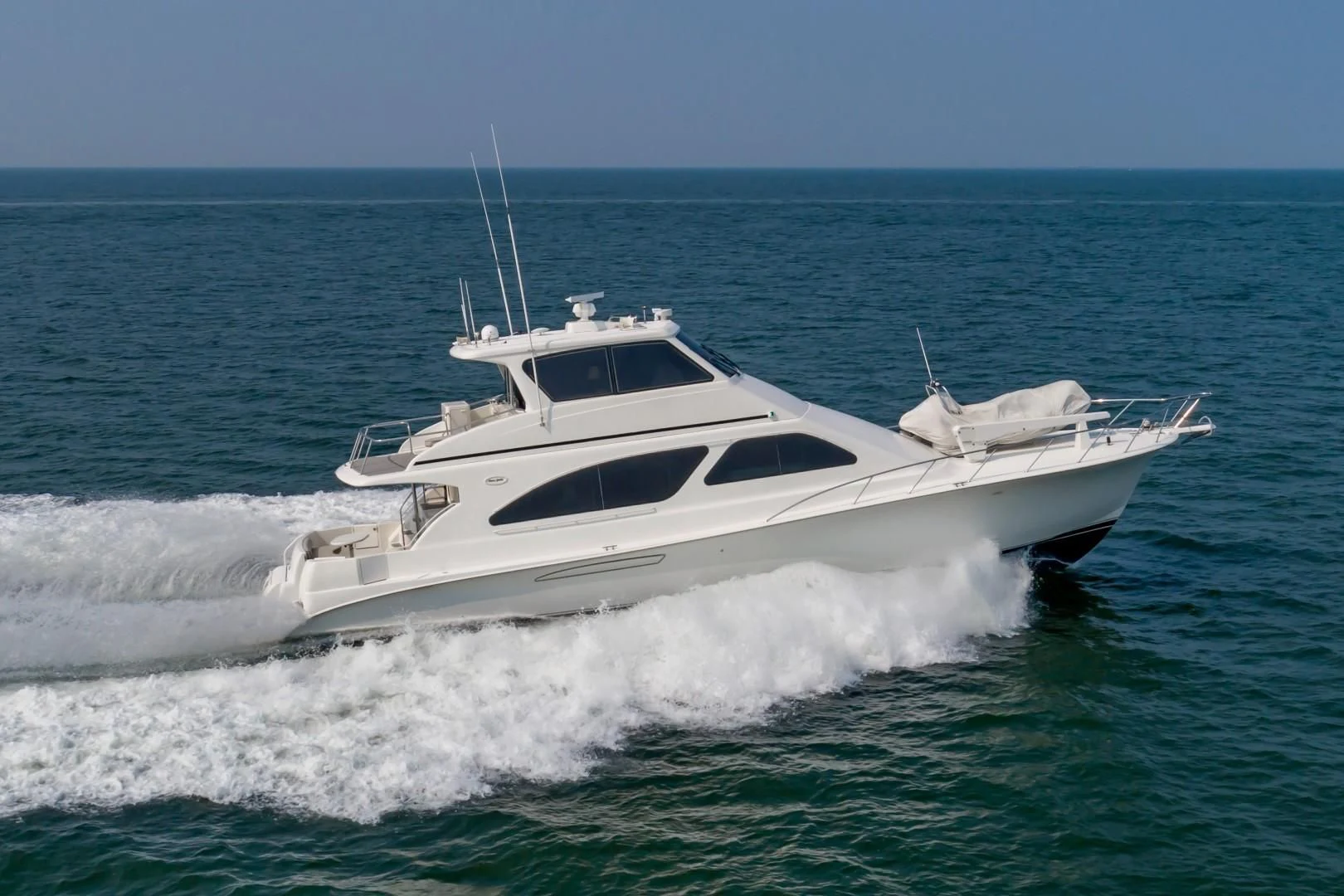 a white yacht in the water aboard DOG HOUSE Yacht for Sale