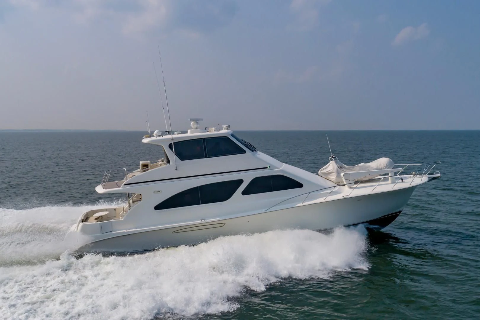 a white yacht on the water aboard DOG HOUSE Yacht for Sale