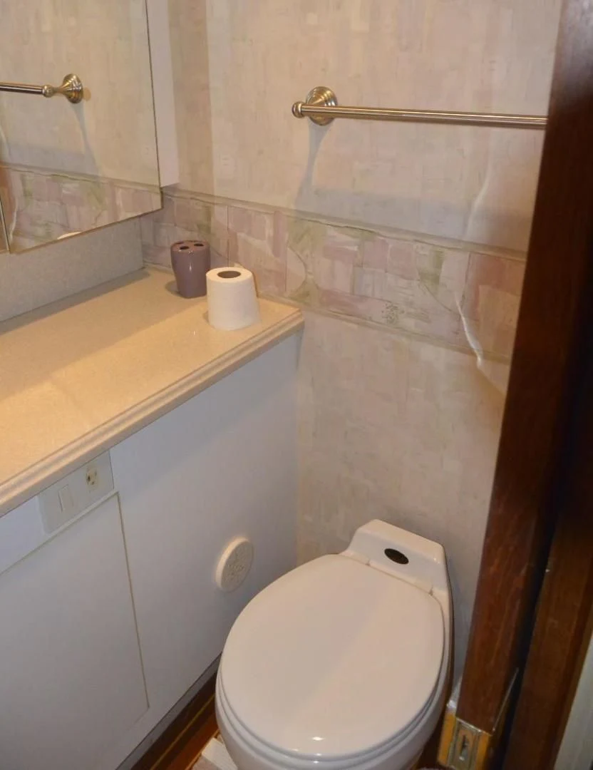 a toilet in a bathroom aboard DOG HOUSE Yacht for Sale