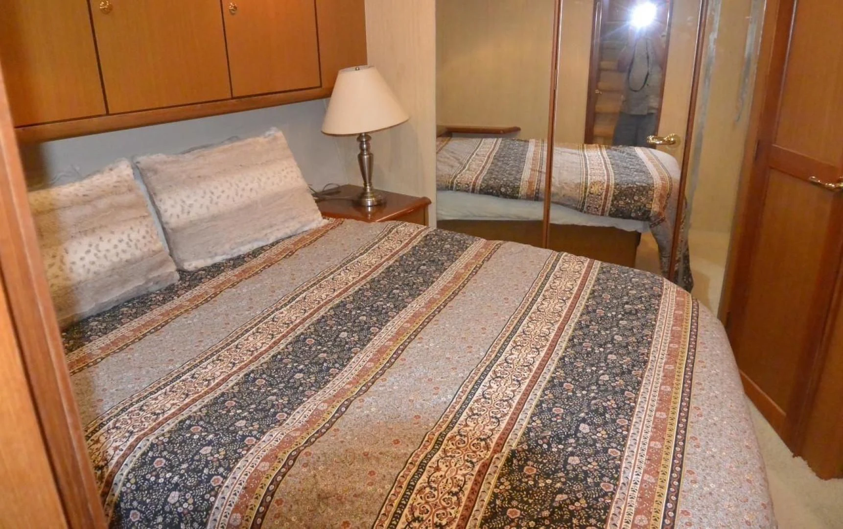 a bed with a lamp on it aboard DOG HOUSE Yacht for Sale