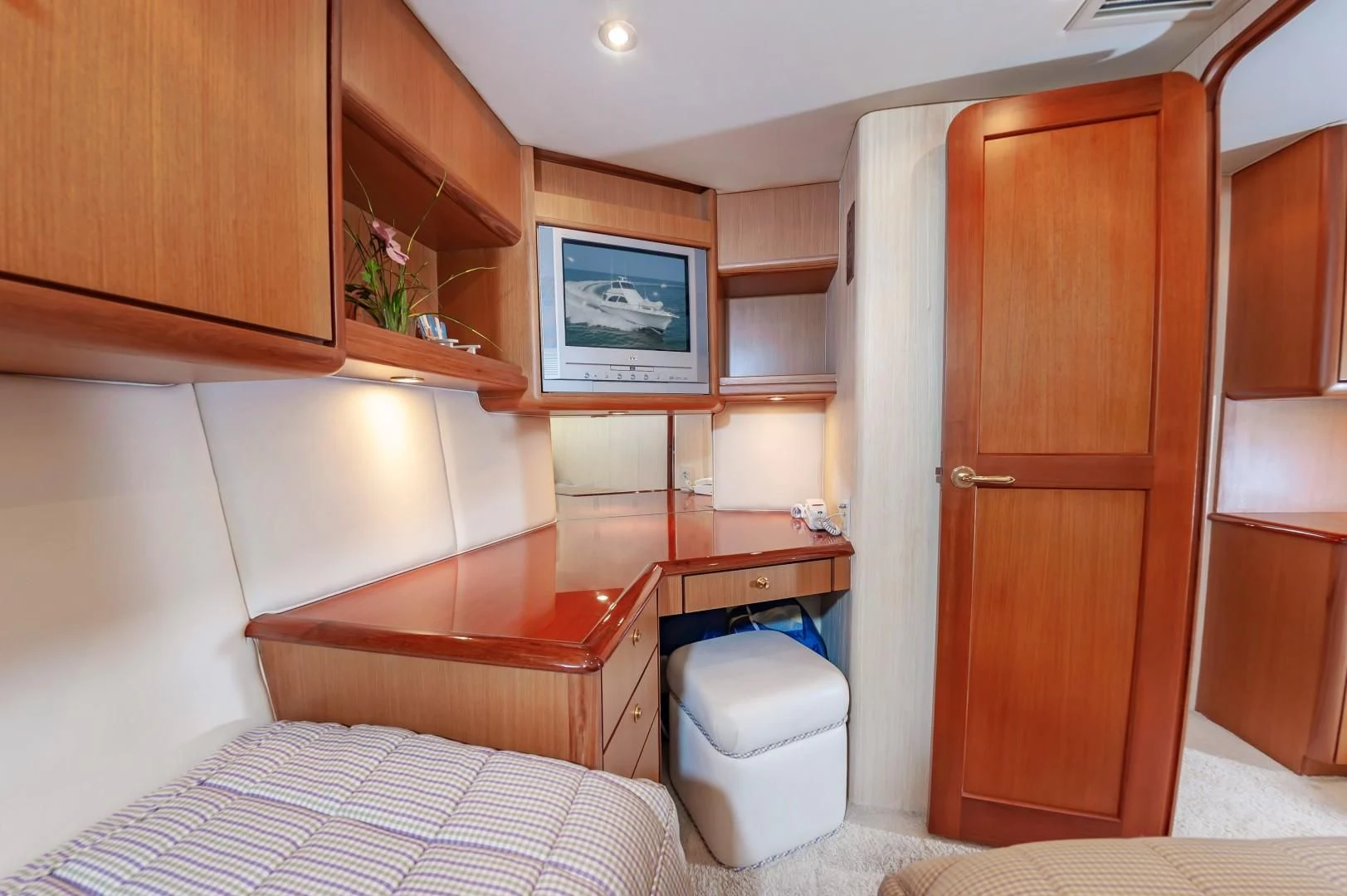 a room with a bed and a television aboard DOG HOUSE Yacht for Sale