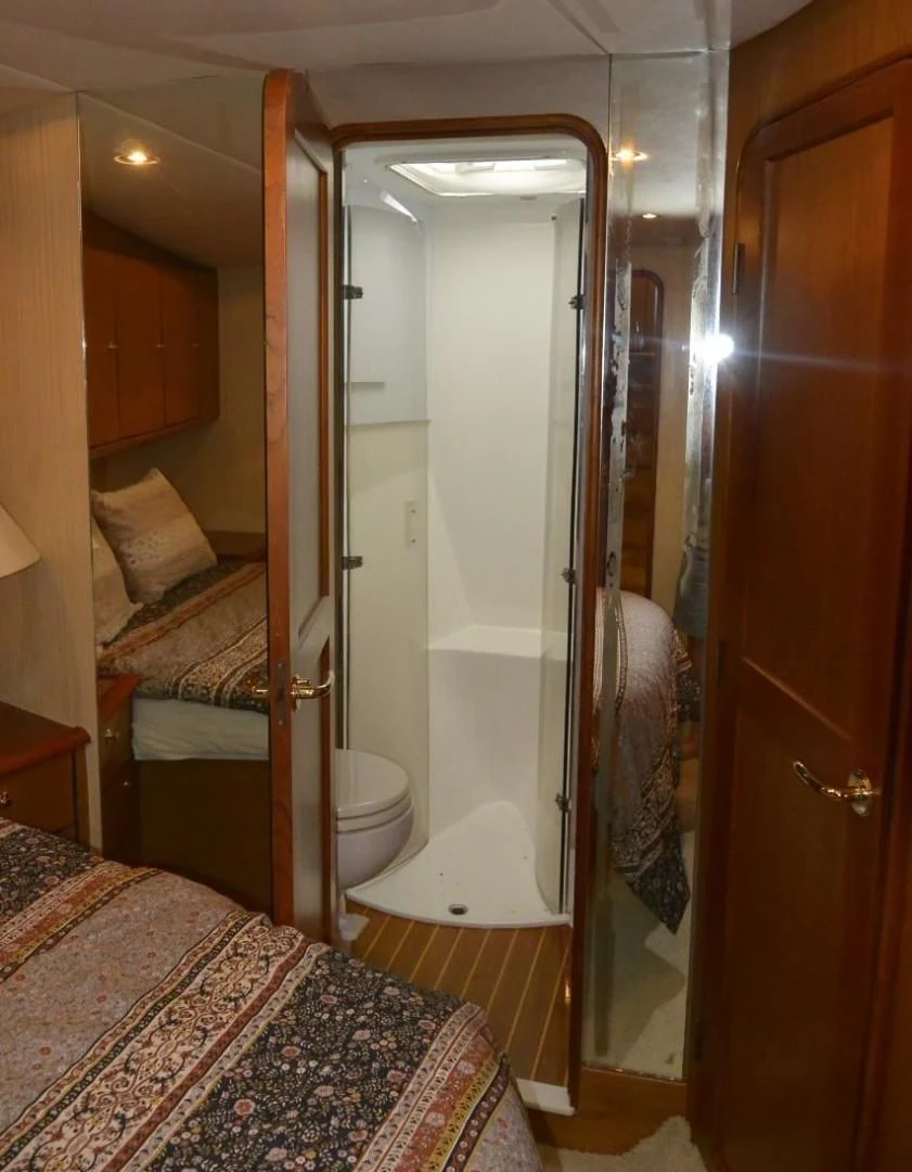 a bathroom with a glass shower aboard DOG HOUSE Yacht for Sale