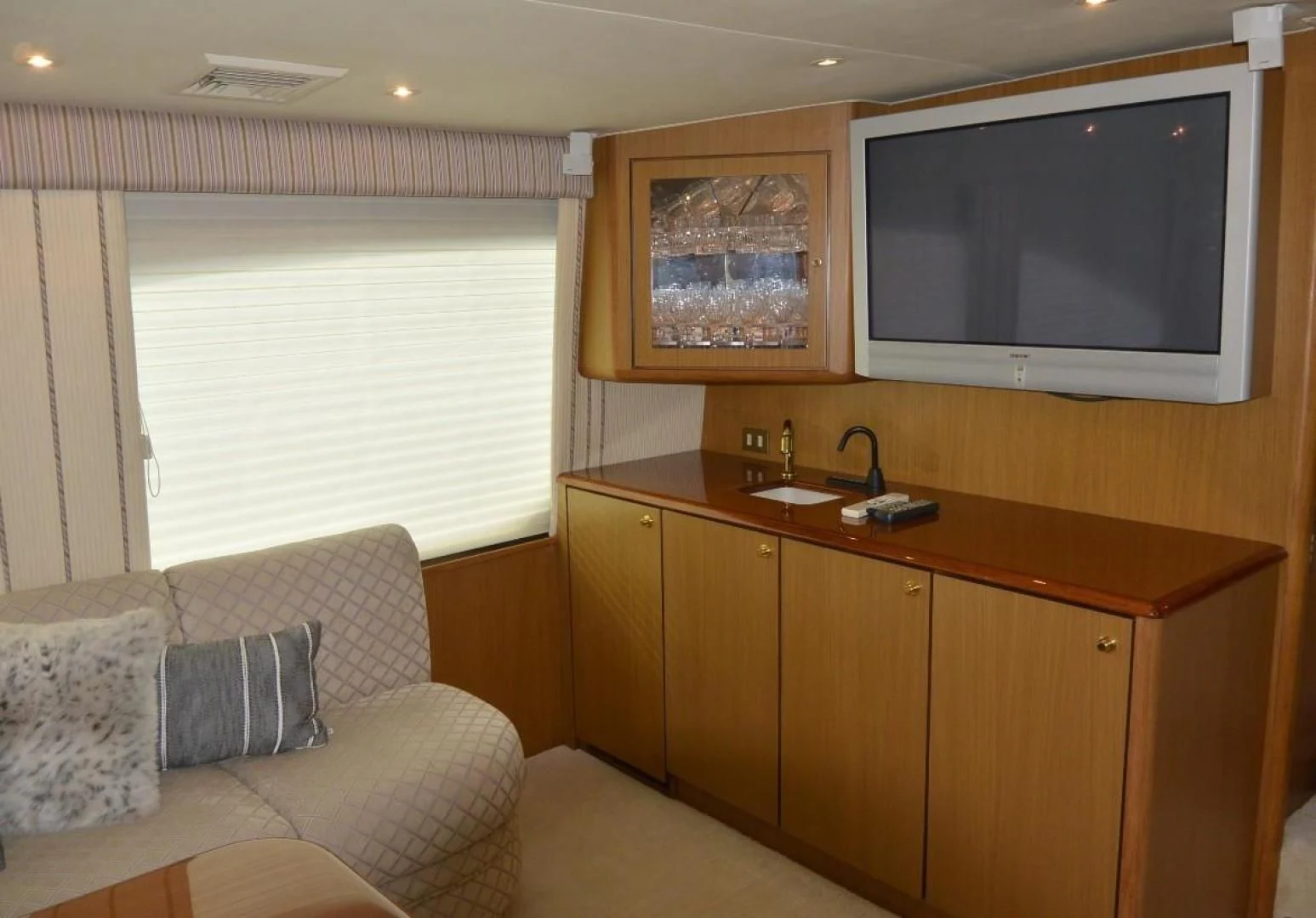 a living room with a couch and a television aboard DOG HOUSE Yacht for Sale