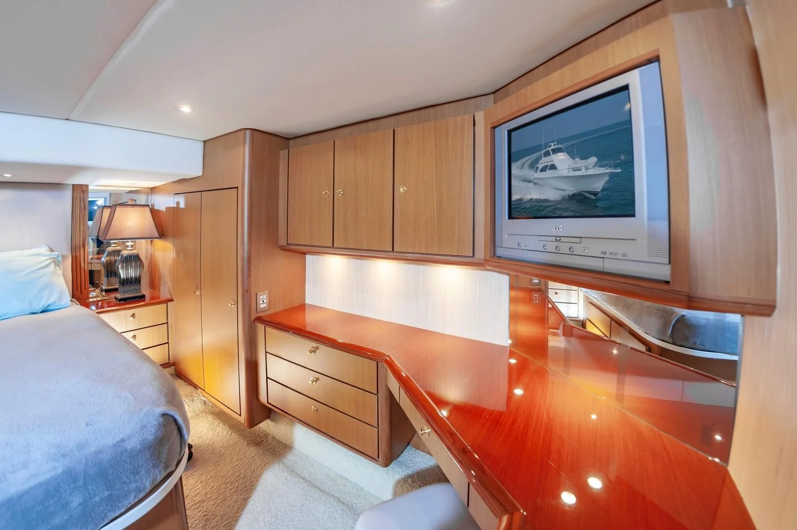 a bedroom with a large television aboard DOG HOUSE Yacht for Sale