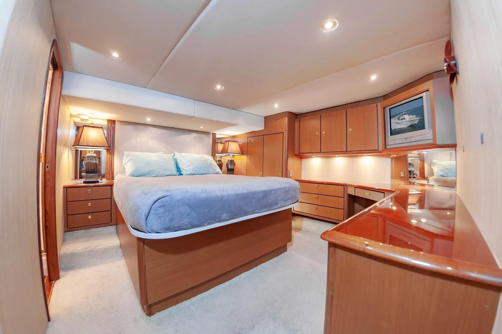 a bedroom with a bed and a desk aboard DOG HOUSE Yacht for Sale