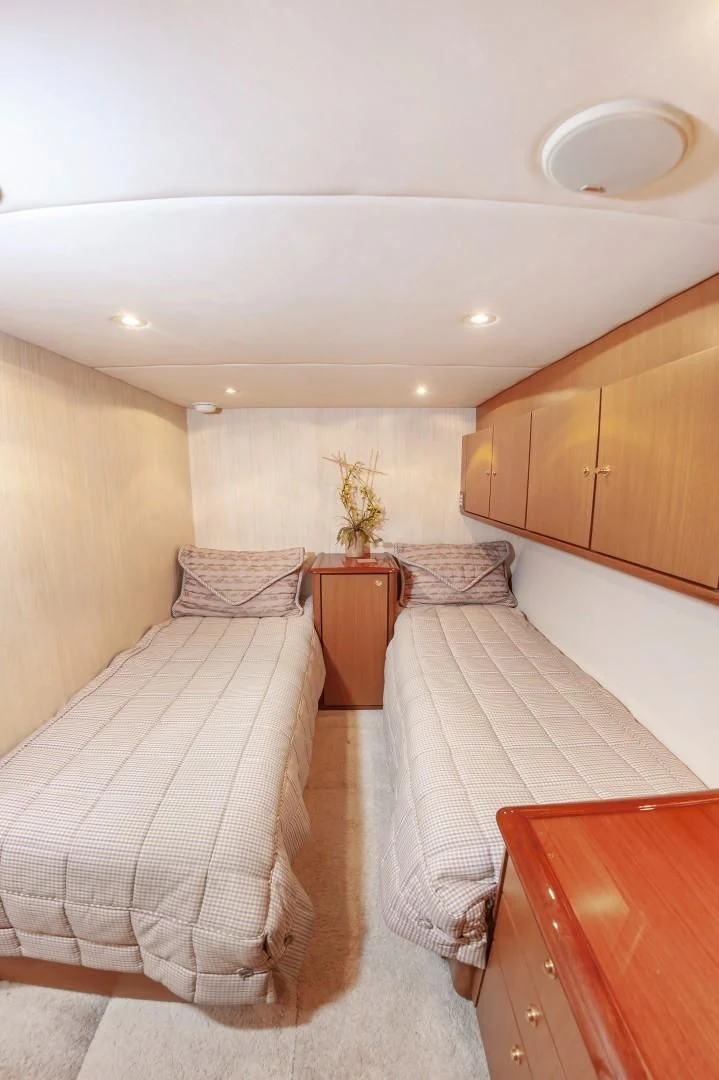 a bedroom with two beds aboard DOG HOUSE Yacht for Sale