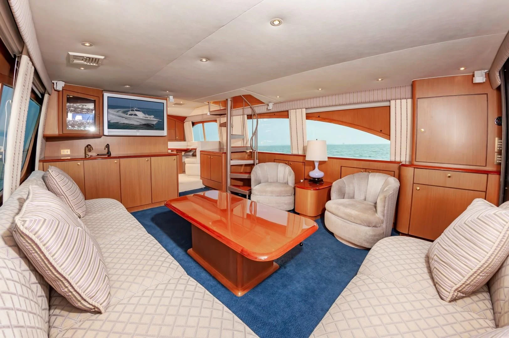 a bedroom with a bed and a table aboard DOG HOUSE Yacht for Sale