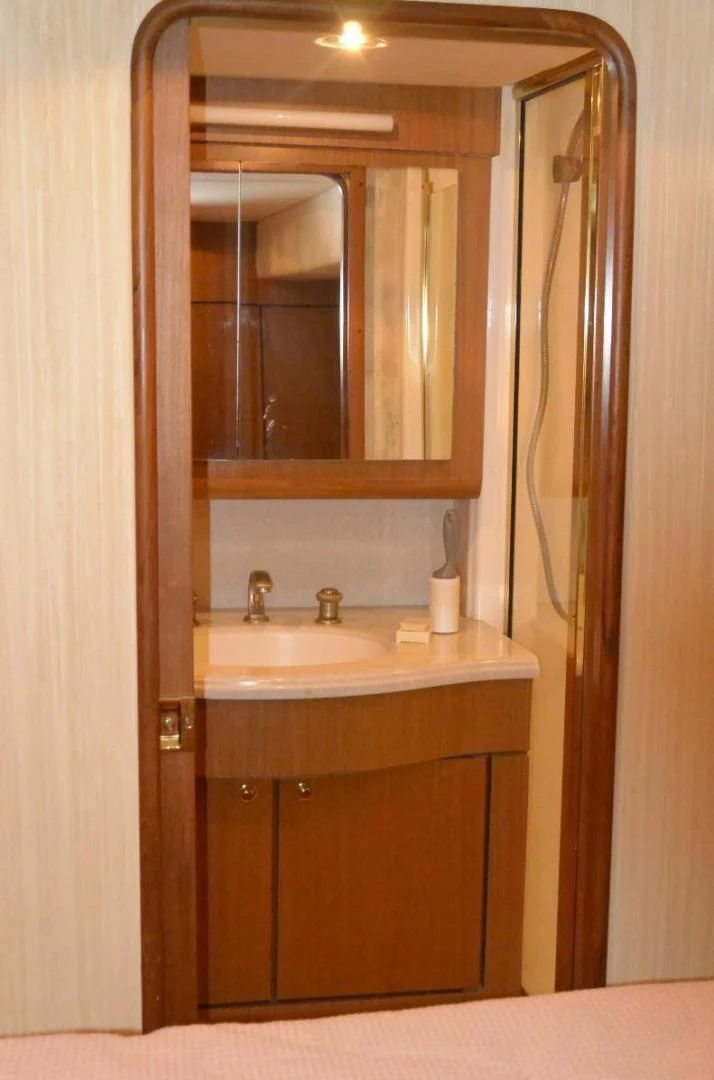 a bathroom with a sink and a mirror aboard DOG HOUSE Yacht for Sale