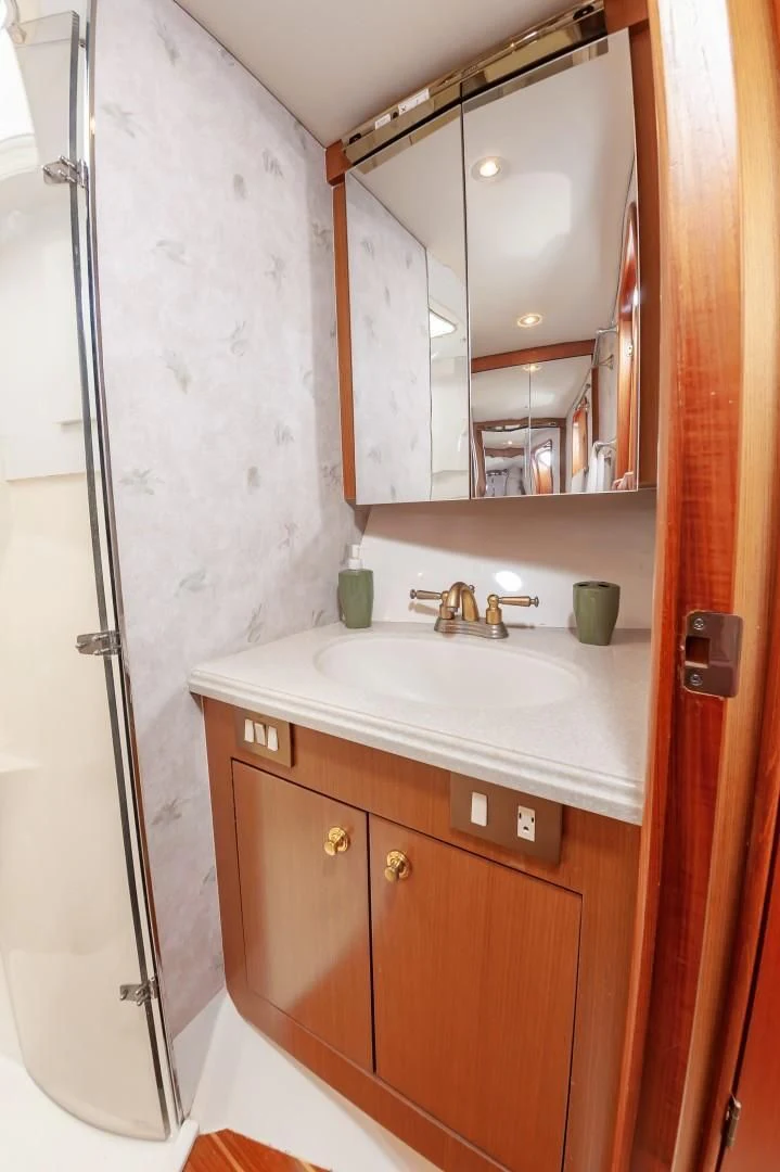a bathroom with a sink and a mirror aboard DOG HOUSE Yacht for Sale