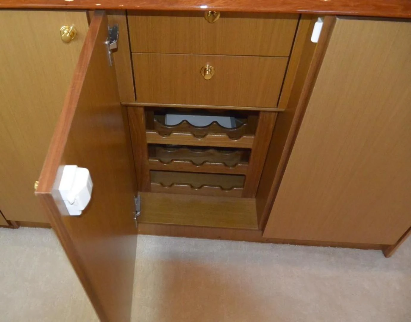 a wooden cabinet with a white tag aboard DOG HOUSE Yacht for Sale
