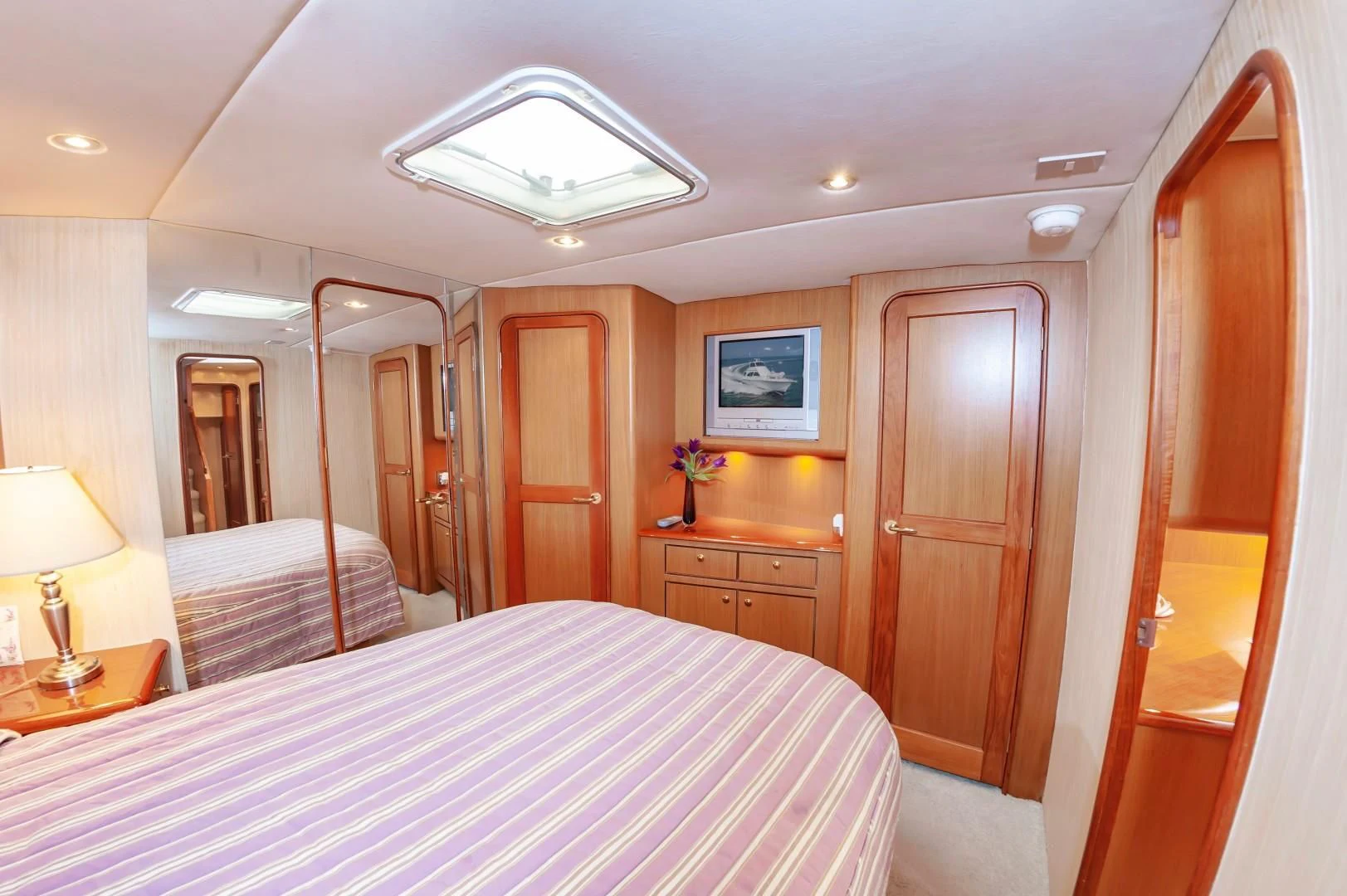 a bedroom with a bed and a desk aboard DOG HOUSE Yacht for Sale
